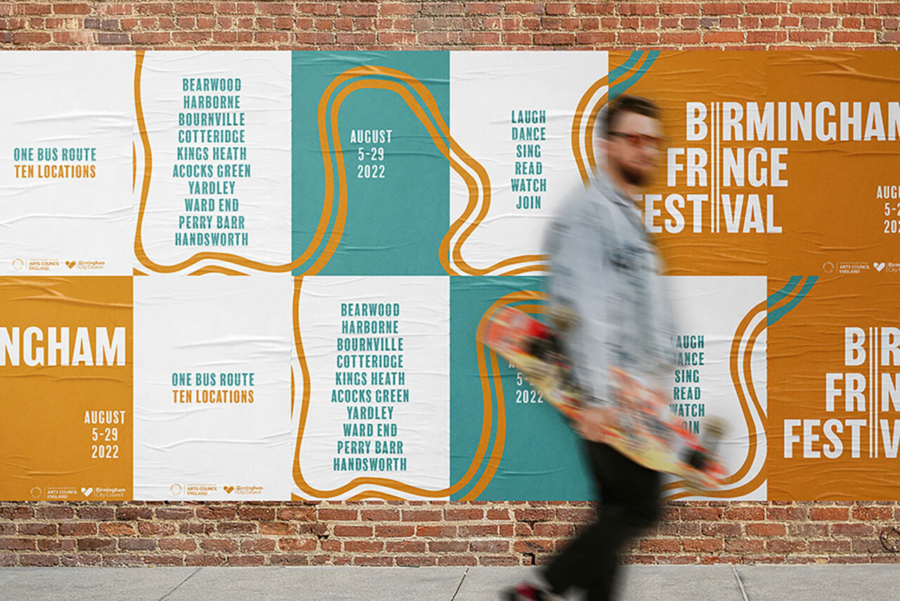 Set of posters across a brick wall with man walking in front.