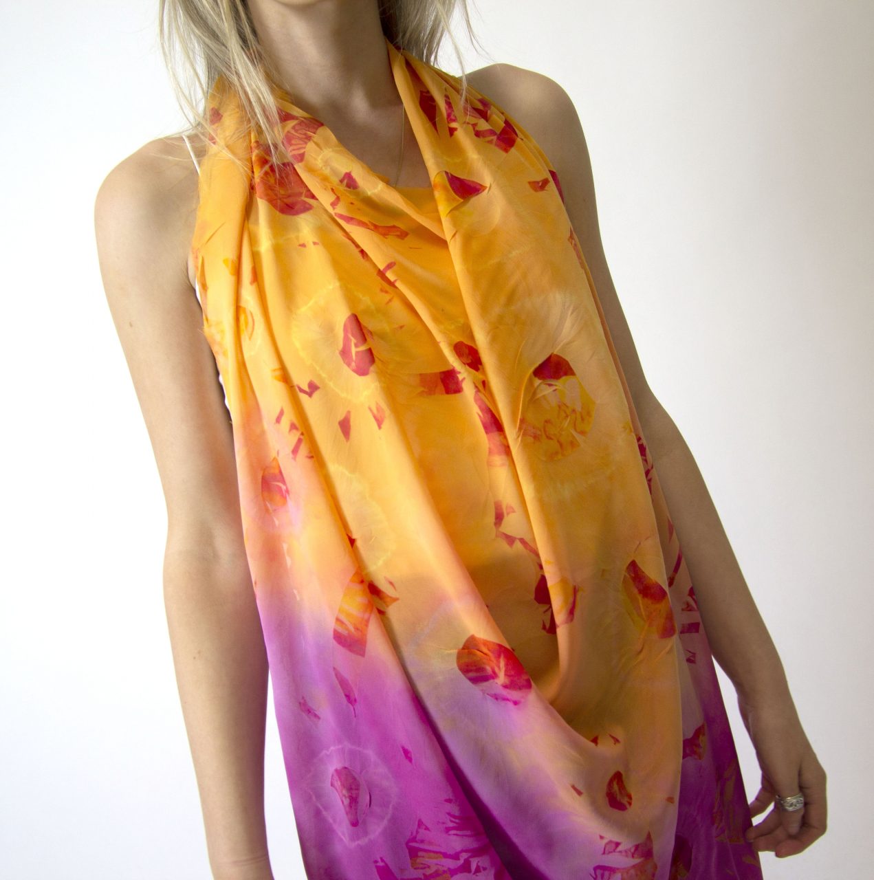 a orange to pink Ombre fabric draped on the body