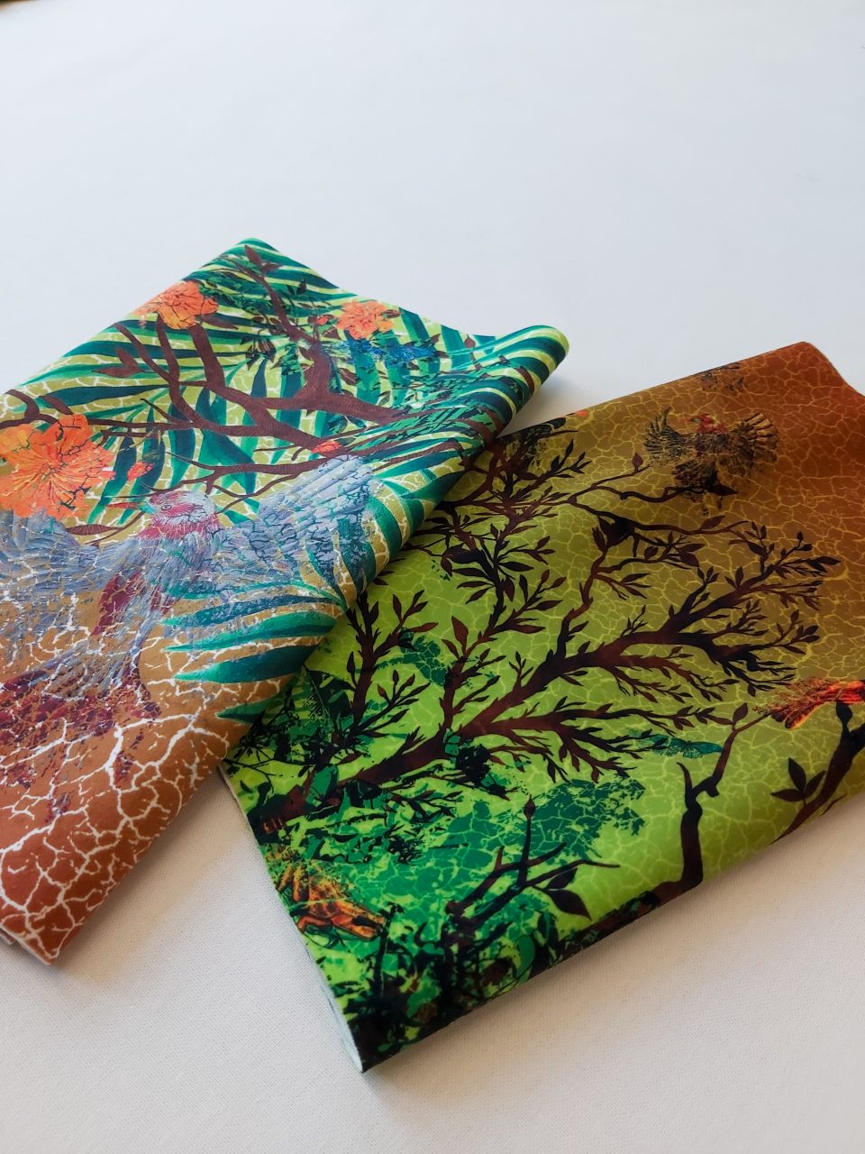 Image of 2 coordinating fabrics showing printed forest scenes