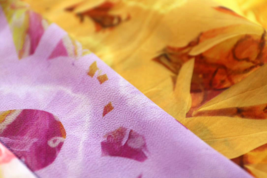 A close up image of two fabrics to show the detail of floral elements.